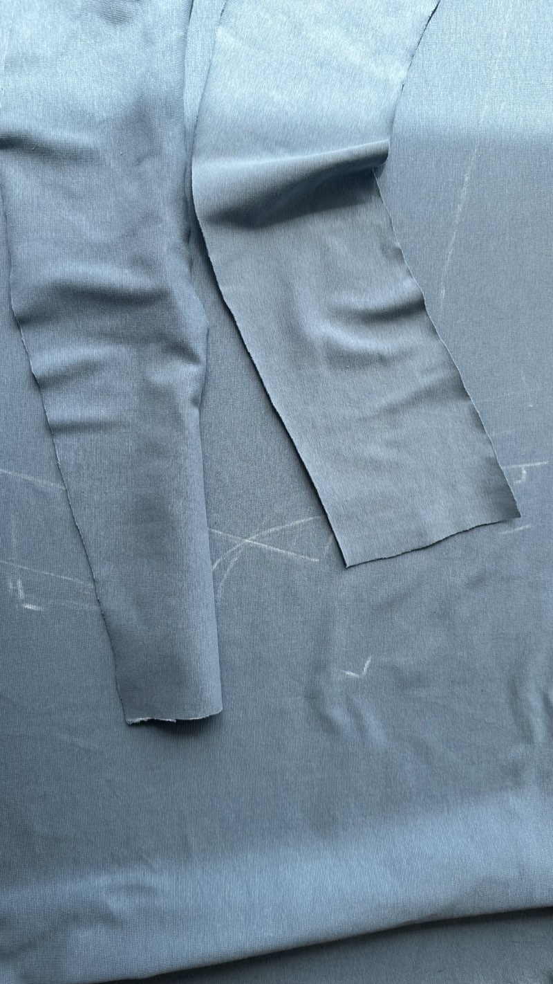 The cut pattern pieces laid on the remaining fabric